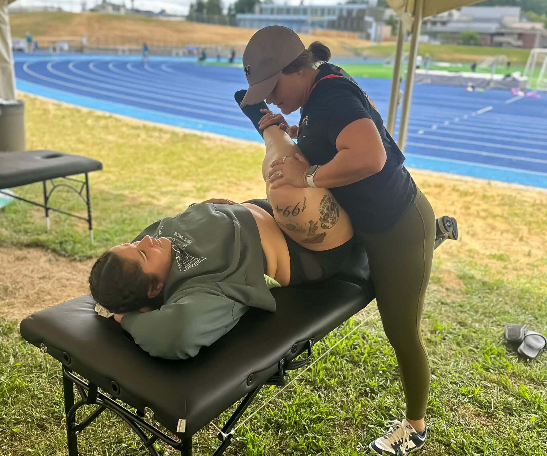 team member aly performing PT for an olympian athlete